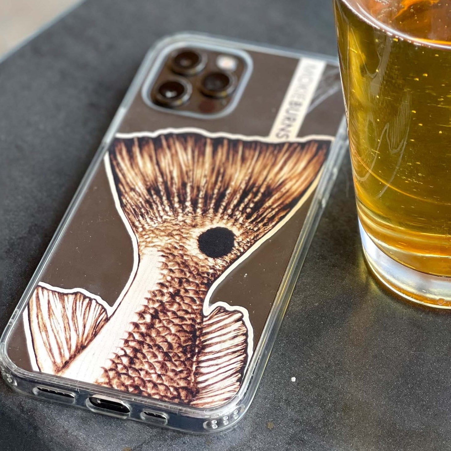 mokie burns inshore fishing redfish tail wood burned artwork, on a clear iphone case for all sizes! Perfect for kids back to school, or your fishing husband or wife. Texas fishing, Florida fishing, Louisiana fishing and South Carolina fishing, this red drum artwork covers it all