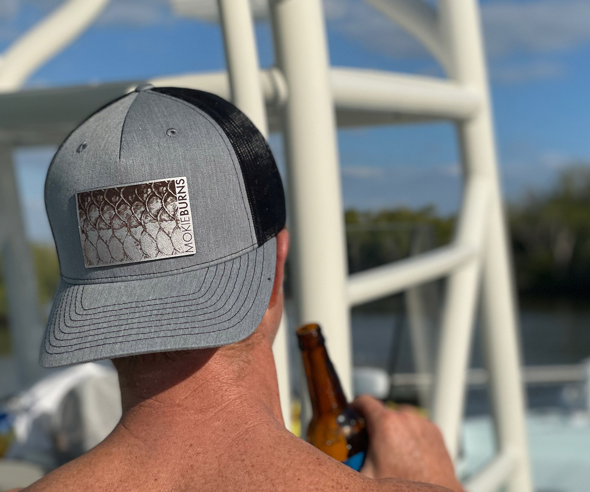 Photo showcasing a Richardson 112 trucker hat with a detailed leather patch featuring a tarpon (AKA silver king), ideal for recreational saltwater fishermen seeking stylish and themed headgear for their fishing trips.