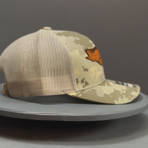 Video showcasing a Richardson 112 trucker hat in digital khaki camo, adorned with a detailed leather patch of a snook, designed specifically for recreational saltwater fishermen looking for a stylish and functional headgear for their fishing adventures.