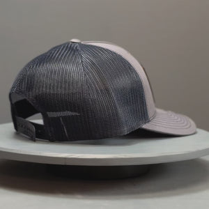 Video showcasing a Richardson 112 trucker hat with a detailed leather patch featuring a redfish tail, ideal for recreational saltwater fishermen seeking stylish and themed headgear for their fishing trips.